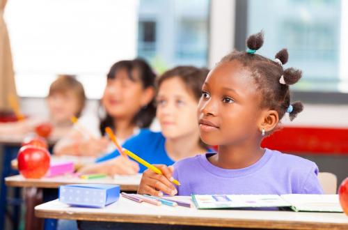 Happy children in a multi ethnic elementary classroom